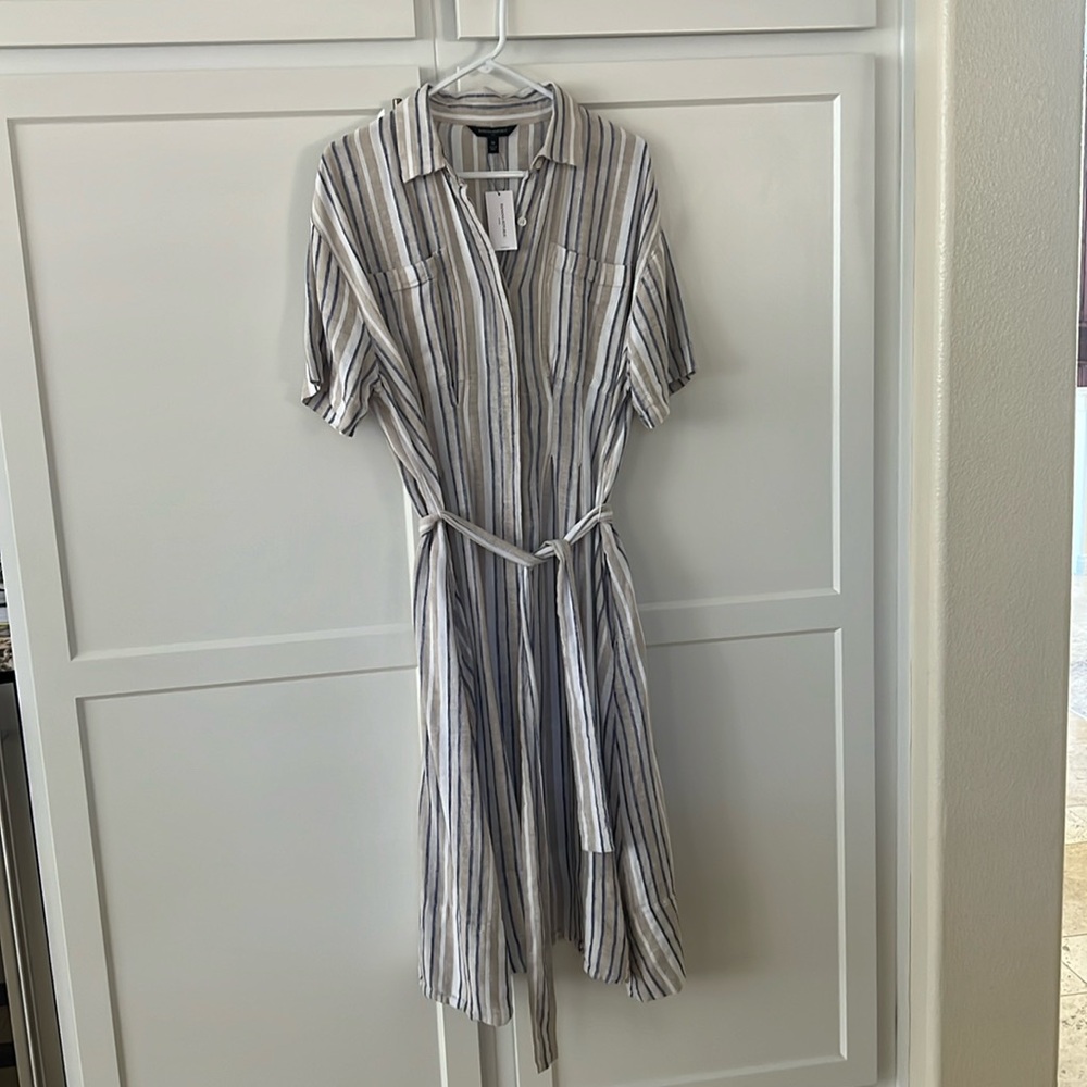 This dress has pockets! It’s to the calf and is 56% linen and 45% rayon.